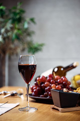 Pouring wine into glass and food background