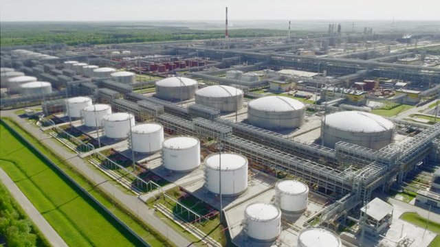 white gas tanks and pipeline at refinery plant bird eye view