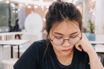 Closeup of young Asian woman with blur background.