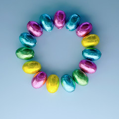 colorful easter candies eggs on blue wooden color