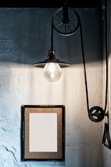 Obraz na płótnie Canvas Interior loft style, Edisson lamp, frame on the wall with an empty place for an inscription.