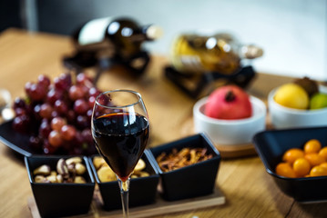 Pouring wine into glass and food background