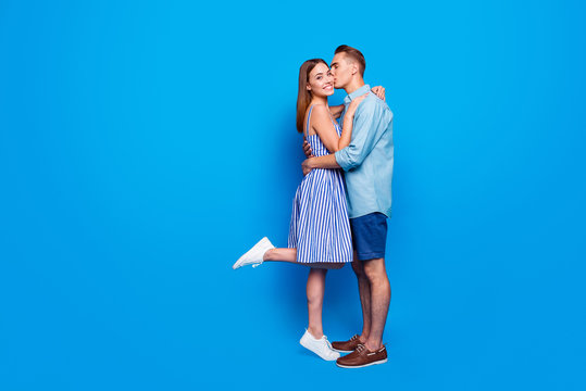 Vertical profile side view of his he her she two nice attractive charming lovely cheerful cheery people holding hands isolated over bright vivid shine vibrant blue turquoise color background