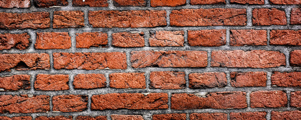 Panorama of old rustic brick wall. Red masonry surface background and texture.