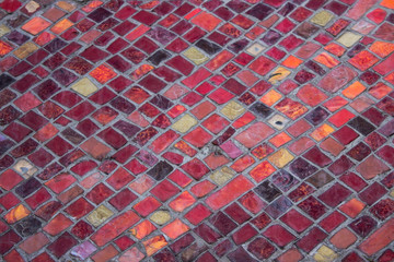 Close up of a colorful mosaic with many small tiles in different shapes, colors and surfaces with...
