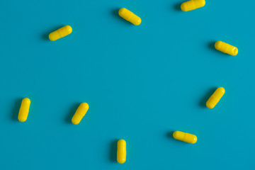 Yellow pills on blue background