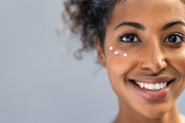 African woman with lotion under the eyes
