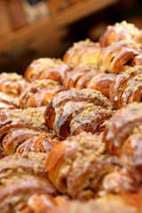 Fresh croissant  with nuts and icing in the cake shop