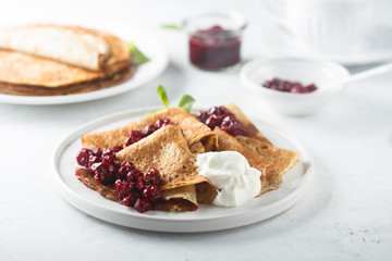 Homemade crepes with cherry sauce