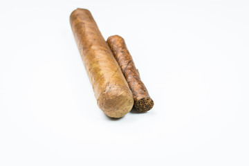 Two best cigars from twisted sheets on white background.