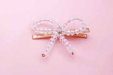 Luxury crystal hair clip on pink fabric with copyspace.