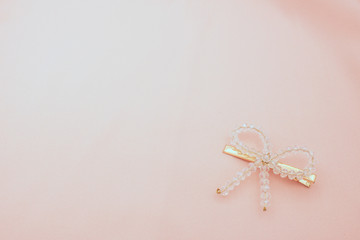 Luxury hair clip on pink fabric with copyspace.