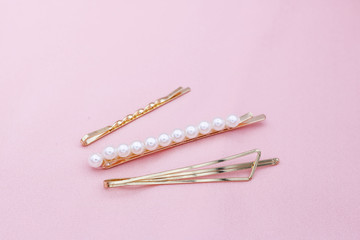 Luxury hair clips on pink fabric with copyspace.