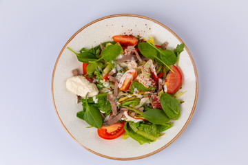 fresh salad with meat, spinach, tomato and sauce