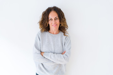 Beautiful middle age woman with curly hair smiling cheerful and happy with arms crossed, laughing with a big smile on face showing teeth over white isolated background