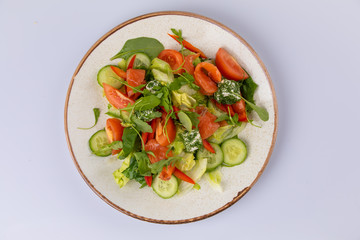 Various fresh mix salad with salmon, tomato, cucumber, onion, bell pepper, healthy food and diet menu.