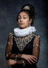 Portrait of a teen girl with dark curly hair, wearing a ruffled collar and  dress in vintage style.