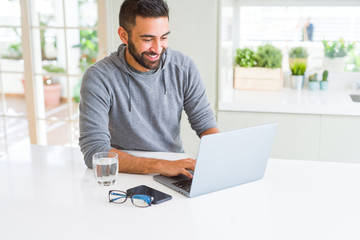 Man smiling working using computer laptop