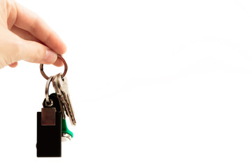 Hand holds a bunch of keys with a chip on a white background
