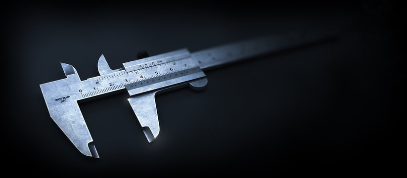 Metal Style. Calliper on the Black Metal Background.