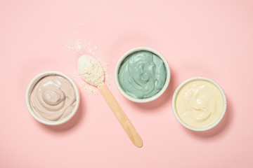 Clay mask on pink bakground, skincare product.