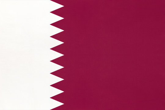 Qatar national fabric flag textile background. Symbol of world asian country.