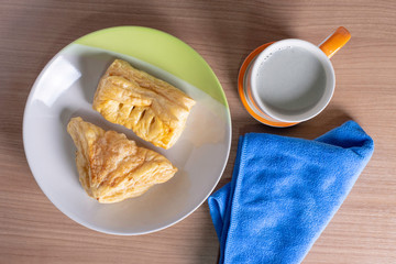 breakfast with cup of fresh milk and croissants