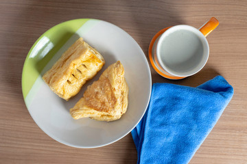 breakfast with cup of fresh milk and croissants