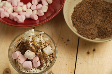 Sprinkling and whisking chocolate sprinkles on luxury drink 