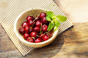 Red  cherry  on wooden bowl , fresh  fruit image for background  orwallpaper.