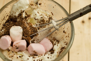 Hot chocolate drink decorated with cream, chocolate and marshmallows