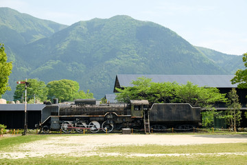 Landscape of Old Train in onsen town, with mountain background in Yufuin, Oita, Kyushu, Japan.