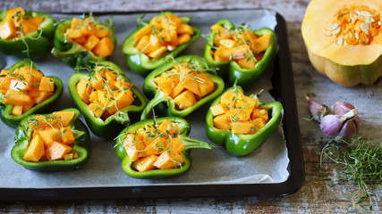 Paprika pepper stuffed with pumpkin slices. Recipe. Autumn food. Vegan food. Diet concept. Selective focus. Macro.
