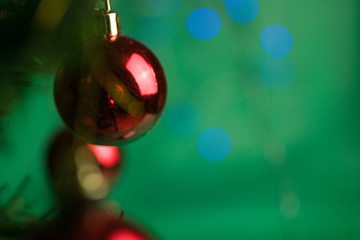   Red Christmas baubles on green background