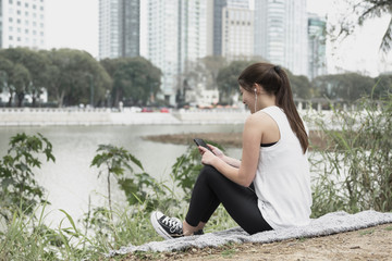 Young woman listening to music outdoor