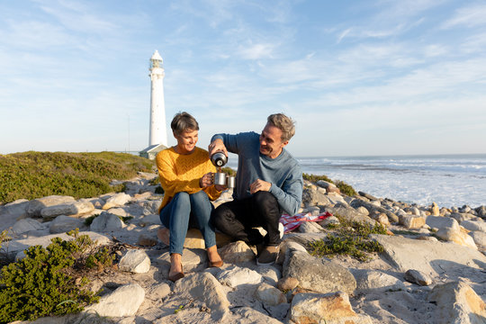 Couple having a picnic by the sea