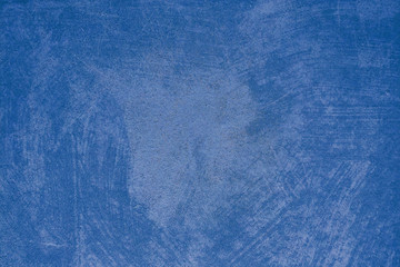 Dark blue paint background on concrete wall with uneven surface, texture
