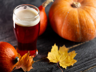 A glass of pumpkin ale on a wooden table
