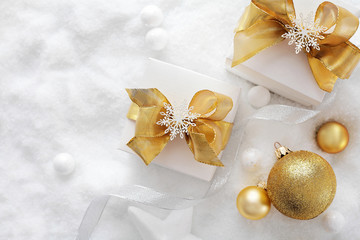 Christmas gift boxes and ornaments on the snow