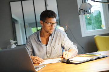 Middle-aged man working on laptop in office