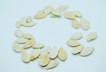 White pumpkin seeds located on a white background