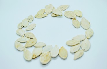 White pumpkin seeds located on a white background