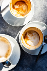 Three Empty Cups of flat white coffee in the cafe,