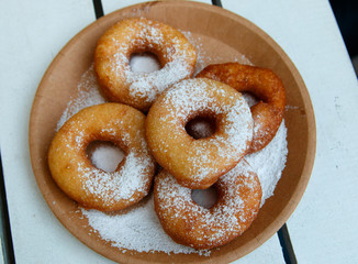 donuts on a plate covered with sugar powder