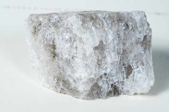 Piece of salt composed mineral, crystal stone salt isolated on white background