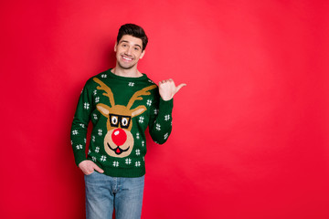 Portrait of funny festive brown hair in deer style stylish sweater point his thumb at copy space...