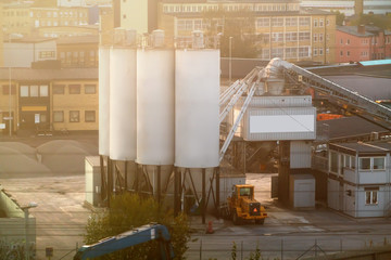 Transport truck at a depot with silos - obrazy, fototapety, plakaty