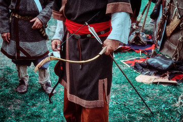 Archer retro tribe stands with a bow in his hand. Reconstruction old life of the nomadic peoples....