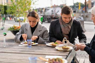 Young couple eating at an outdoor restaurant