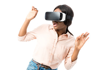 shocked african american woman in shirt with virtual reality headset isolated on white